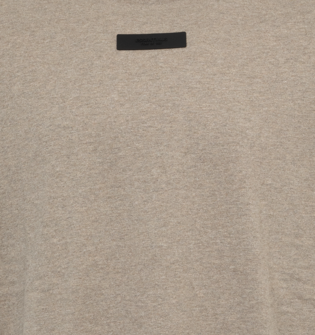 Image 2 of 2 - GREY - FEAR OF GOD ESSENTIALS Short Sleeve T-Shirt featuring rib knit crewneck, rubberized logo patch at chest and back, dropped shoulders and dolman sleeves. 100% cotton. Made in Viet Nam. 