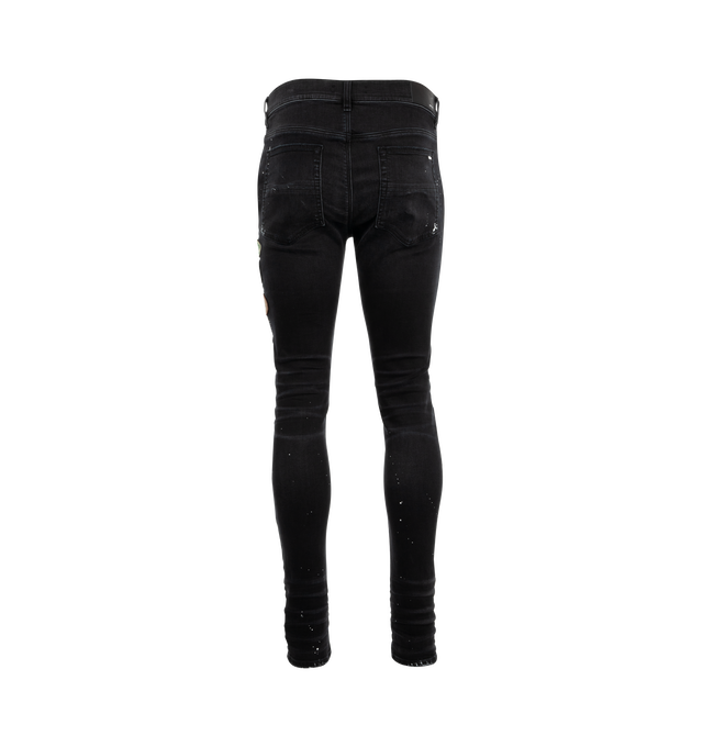 Image 2 of 3 - BLACK - Amiri Vintage Patch Skinny Jenas are a 5-pocket style with a button fly closure, a distressed and ripped finish, and a logo patch at the rear. Made in USA.  