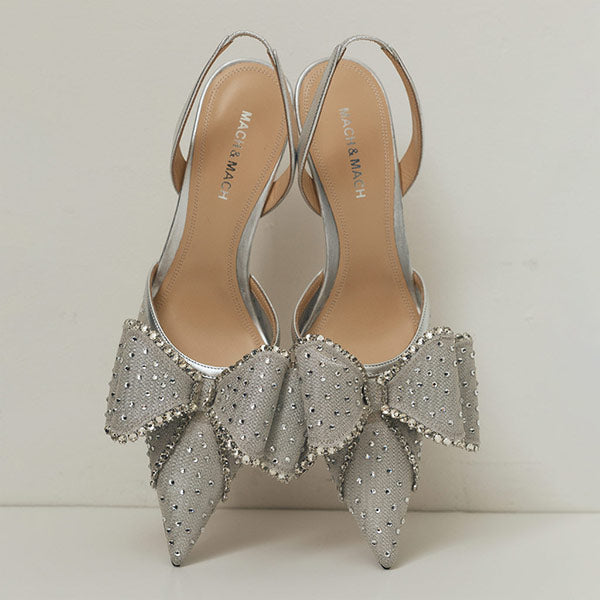Silver high-heeled shoes with decorative bows by Mach & Mach