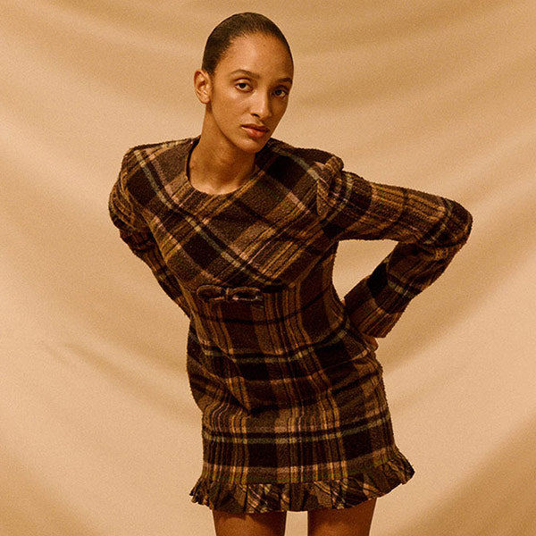 Woman wearing a plaid dress by Acne Studios