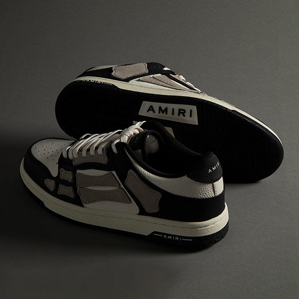 Skeleton motif sneakers in grey, black and white leather by Amiri, available online.