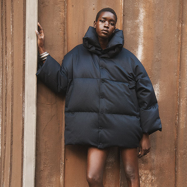 Woman wearing Alaia oversized puffer jacket