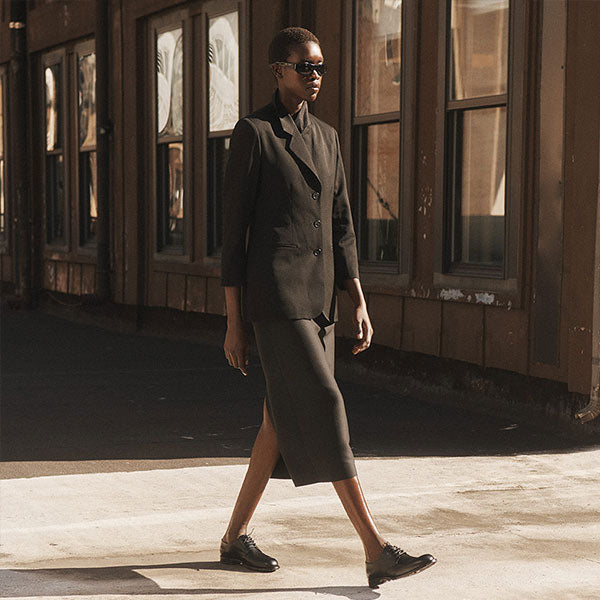 Woman wearing Black blazer, skirt and lace-up dress shoes by The Row