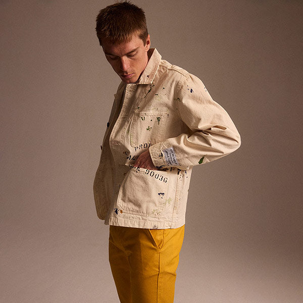 Gallery Dept. cream painters jacket and yellow chino pants, available online.