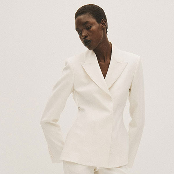 Woman wearing white blazer by Acne Studios