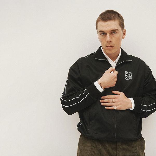 Man zipping up Loewe track jacket