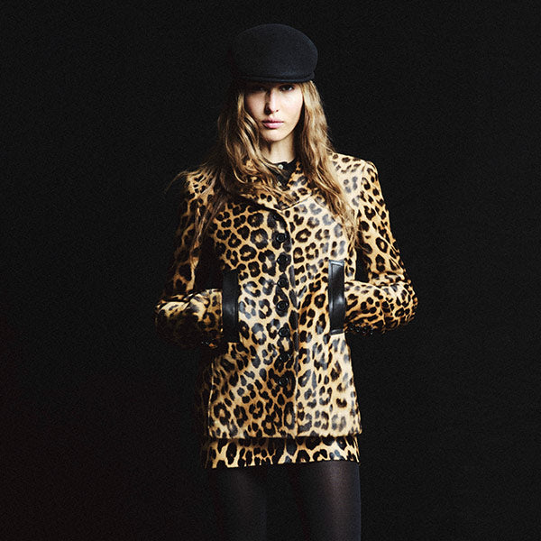 Woman wearing a leopard print haircalf coat and skirt by Khaite