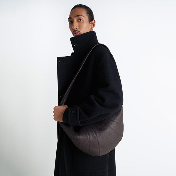 MAN WEARING BLACK COAT AND LEMAIRE Large Croissant Bag 