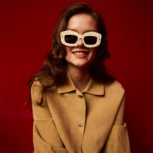 Woman wearing Loewe TURN-UP lightweight suede lambskin jacket and Screen sunglasses crafted in acetate with Swarovski crystal embellishments 