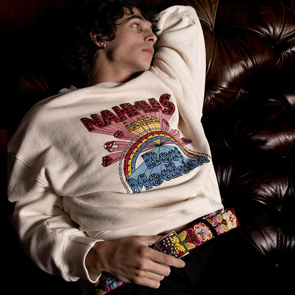 Man wearing Nahmias white sweatshirt with multi-colored graphic