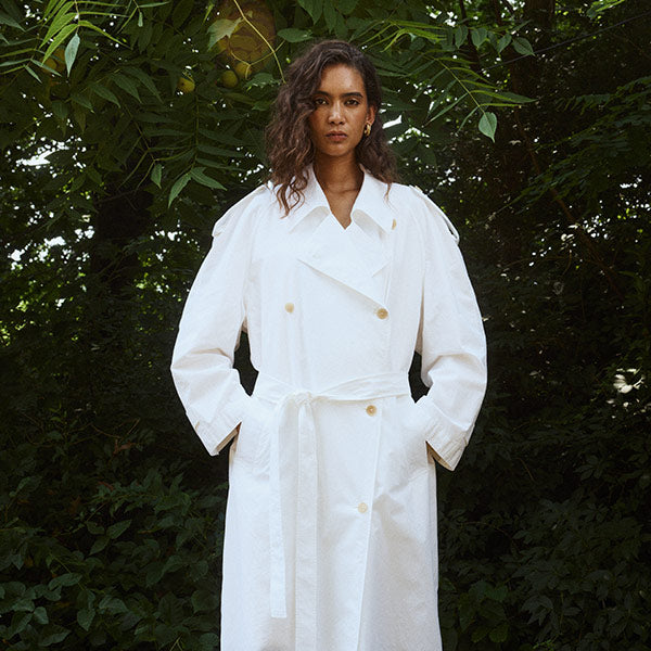 woman wearing white Denver coat by The Row