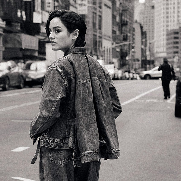 Woman wearing Levi’s® x Sacai denim jacket and pants
