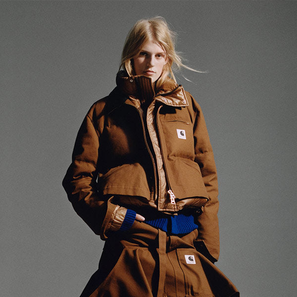 Person wearing a brownsacai x carhartt wip duck puffer jacket and canvas skort