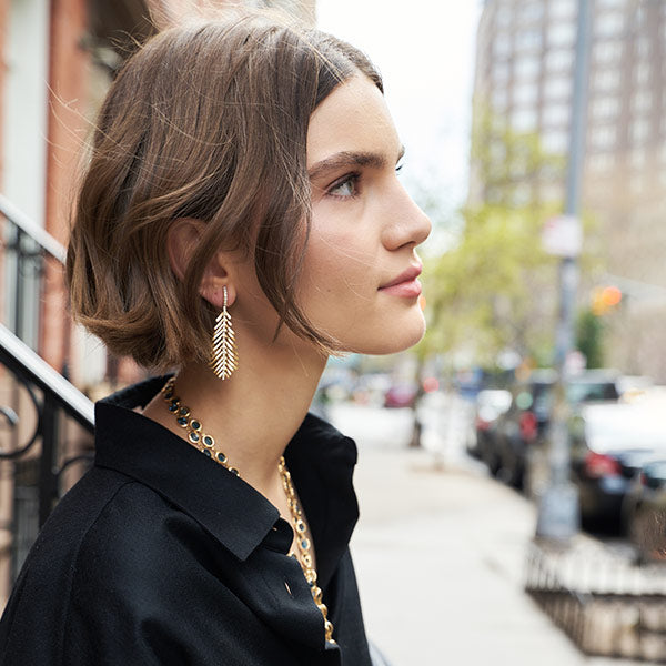 Woman wearing Sidney Garber feather earrings
