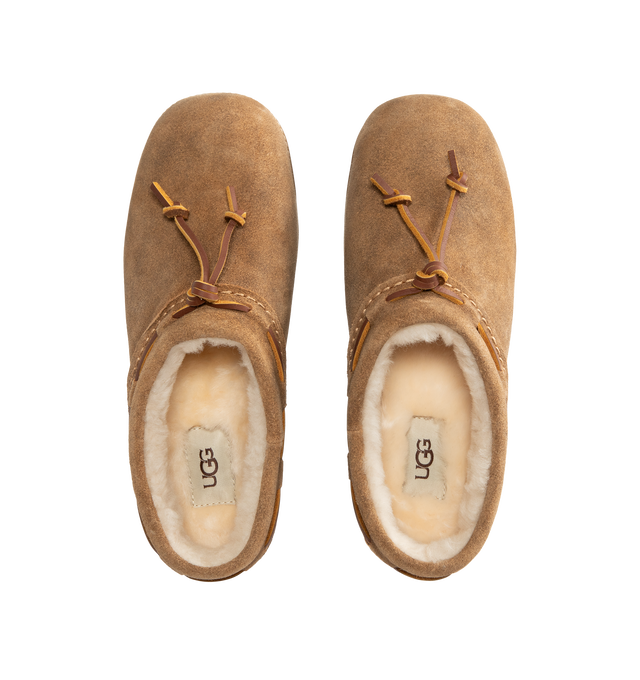 Image 4 of 4 - BROWN - UGG women's bucked clog made in soft suede with an elevated, worn-in feel and a leather whipstitch detail, signature sheepskin lining and cushy rubber platform sole. Features sugarcane EVA midsole, molded rubber outsole, woven label with UGG Logo on insole and UGG Logo embossed suede heel label. 