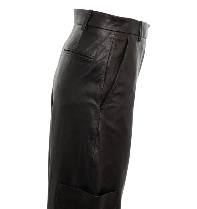Image 3 of 4 - BLACK - KHAITE Caiton Leather Wide-Leg Cargo Pants featuring cargo pants in lambskin leather with leg patch pockets, mid rise sits high on hip, flat front, angled side slip pockets, back welt pockets, wide legs, full length and hook zip fly and belt loops. Leather. Made in Romania. 