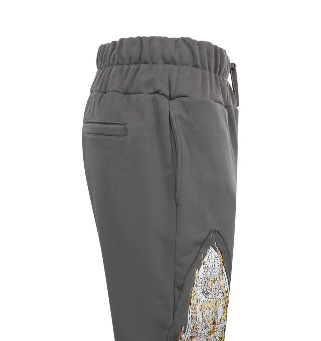 Image 3 of 3 - GREY - WHO DECIDES WAR Triple Flame Glass Sweatpant featuring elastic waistband with drawstring, side slit pockets, back welt pockets and graphic print patches on legs. 100% cotton. 