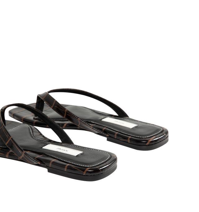 Image 3 of 4 - BROWN - Toteme Women's Croco-Embossed Flip-Flops are crafted from croc-embossed leather and feature a minimalist thong silhouette with an open square toe. Designed with a padded sheepskin footbed featuring a subtle logo patch, these designer sandals are finished with a calfskin leather sole for a refined take on an everyday warm-weather essential. Part of Toteme's Garderob collection. Upper: Leather. Footbed: Sheepskin. Sole: Calfskin Leather. Color: Dark Brown. Made in Italy. 