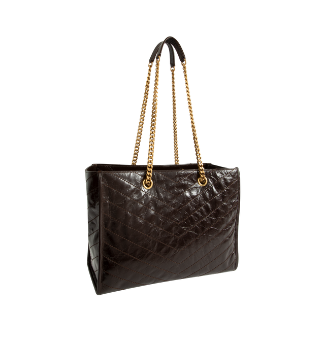 Image 2 of 3 - BROWN - Saint Laurent Niki Shopping Bag in vintage leather featuring chevron topstitching, cotton lining, bronze-tone hardware, magnetic snap-button closure and one zip pocket making it ideal for work, travel, or day-to-day use. Dimensions: 13" x 10.6" x 5.5". Strap drop: 10.6". Fits everyday essentials such as a 13" laptop, tablet, wallet, phone, sunglasses, keys, and a small pouch. Main Material: Calfskin Leather. Made in Italy.  