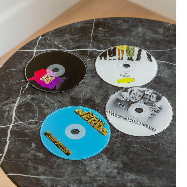 Image 6 of 6 - MULTI - Curves x The Blog Era Mixtape CD Coasters (Set of 4)- The Blog Era has collaborated with Curves on a collection that celebrates a transformative period of time in hip-hop when the internet changed the music businessoffering fans a piece of nostalgia.  A set of four acrylic mirror coasters. D 12cm [3mm thick].  Note* do not clean with glass mirror cleaner. 