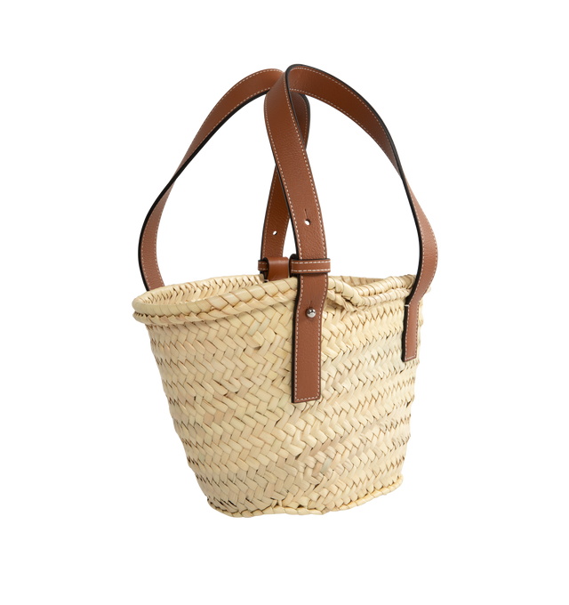 Image 2 of 3 - NEUTRAL - LOEWE small traditional basket bag elevated with a classic handwoven body and calfskin top handles. This small version is made in Spain using raffia leaves that have been cultivated, harvested, sun-dried and handwoven by artisans in Morocco. Featuring contrast straps and panel, shoulder or top handle carry, adjustable top handles, unlined, embossed LOEWE Anagram calfskin patch. 