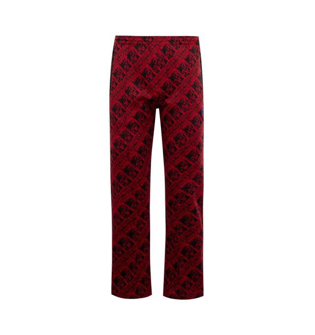 Image 1 of 3 - RED - NEEDLES Track Pant featuring jacquard graphic pattern throughout, concealed drawstring at elasticized waistband, three-pocket styling, zip pockets, logo embroidered at front, pinched seams at front and partial mesh lining. 100% polyester. Trim: 100% rayon. Made in Japan.