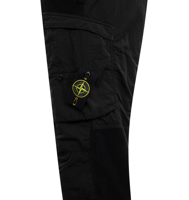 Image 3 of 3 - BLACK - STONE ISLAND Fleece Sweatpants featuring panelled design, signature detachable Compass badge, elasticated drawstring waistband, tapered leg, elasticated ankles, two side slit pockets and two side zip-fastening pockets. 86% cotton, 14% polyamide. 