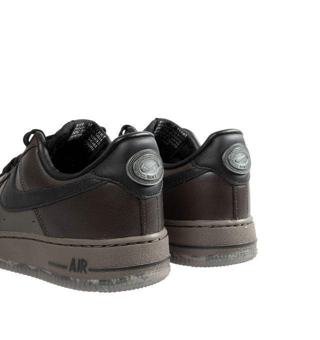 Image 4 of 5 - BLACK - Nike Air Force 1 Low lace-up sneakers in a Black Tea and Petra Brown color combo. Features Nike Air cushioning, low-cut silhouette, padded collar, foam midsole, perforations on toe and rubber outsole. 