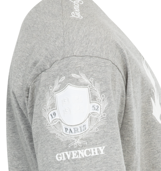 Image 2 of 3 - GREY - GIVENCHY Crest T-Shirt featuring short-sleeves, crew neck, GIVENCHY Crest emblem with mixed prints and embroideries on the front and sleeves, small 4G emblem printed on the lower back and classic fit. 100% cotton. 