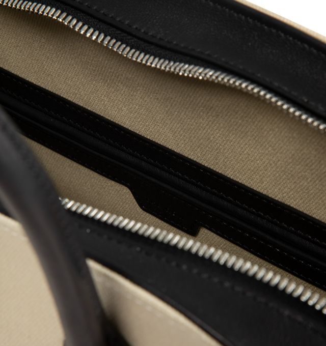 Image 3 of 3 - NEUTRAL - The Row Womens Agnes 15 Canvas Bag is crafted from cotton canvas and cattle leather. Features slim shoulder straps, an open interior with cotton lining, and saddle leather trim. Main Material: Cotton and Cattle Leather; Lining: Cotton. Dimensions: 17.52" W x 9.85" H x 8.66" D; Shoulder Strap Drop: 6.7". Made in Italy. 