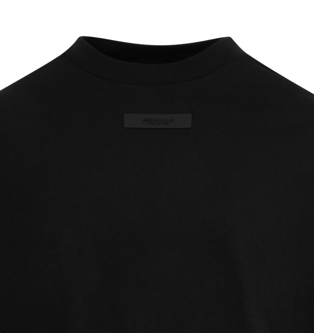 Image 2 of 2 - BLACK - FEAR OF GOD ESSENTIALS Crewneck T-Shirt featuring rib knit crewneck, rubberized logo patch at chest and back, dropped shoulders and dolman sleeves. 100% cotton. Made in Viet Nam. 