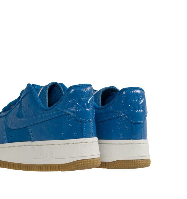 Image 3 of 5 - BLUE - NIKE Air Force 1 snaker crafted from premium leather and textiles, with a foam midsole and rubber sole. Featuring Star Blue ostrich-textured leather upper, Metallic Gold graphics,  padded collar,  gum outsole with Nike Air cushioning for lightweight, all-day comfort. 