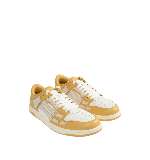 Image 2 of 5 - NEUTRAL - Amiri Men's Quad Skel Top Low Sneakers are a lace-up style with perforation details, signature graphics, leather appliques, and two-tone rubber soles. Leather uppers. Made in Vietnam. 