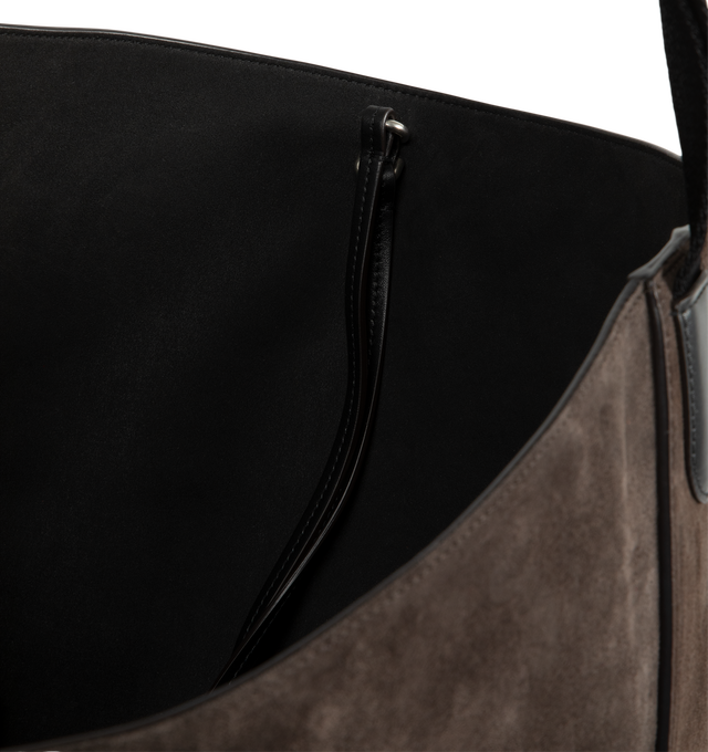 Image 3 of 3 - BROWN - Moncler Women's Carlo Suede Shoulder Bag is crafted from tactile cow suede and features a soft hobo silhouette accented with leather piping and contrast blanket stitching. Designed for versatile hand or shoulder carry, this designer bag features a leather handle, nylon lining, a removable zipped pouch, and signature Moncler logo detailing at the bottom. Leather Exterior: Cow Leather. Leather Inserts: Cow Leather. Lining: 100% Polyamide/Nylon. Dimensions: 28 x 31 x 18 cm. Fits a large  