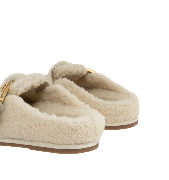 Image 3 of 4 - WHITE - Fendi Women's Feel Sheepskin round-toed sabots with FF strap. Made of white sheepskin. White split leather details. Gold-finish metalware. Made in Italy.  Composition: 100% sheep fur, 100% calf leather, inside: 100% calf leather, 100% sheep fur. 