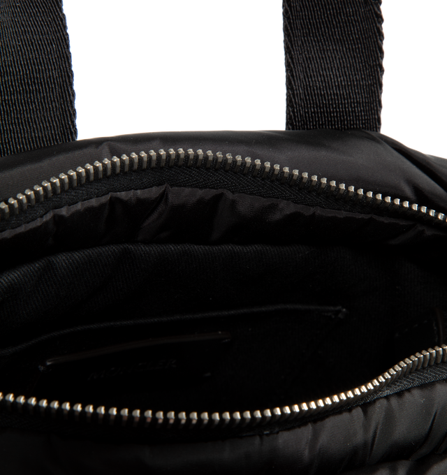 Image 3 of 3 - BLACK - MONCLER Micro Caradoc Puffer Crossbody Tote featuring quilted water-repellent nylon, trapezoid silhouette, top zip closure, top carry handles and adjustable shoulder strap. Lined with down fill. Textile with leather trim. Made in Hungary. 