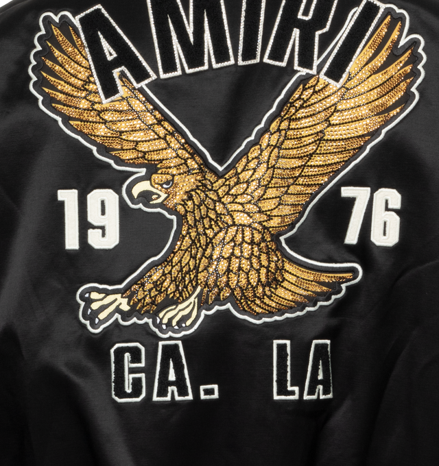 Image 4 of 4 - BLACK - AMIRI Eagle Varsity Bomber Jacket featuring embroidered chest logo, front logo, logo at the back, logo at the back label, side pockets, button fastening, front buttoned closure, long-sleeved and embroidered details. 75% wool, 25% nylon. 