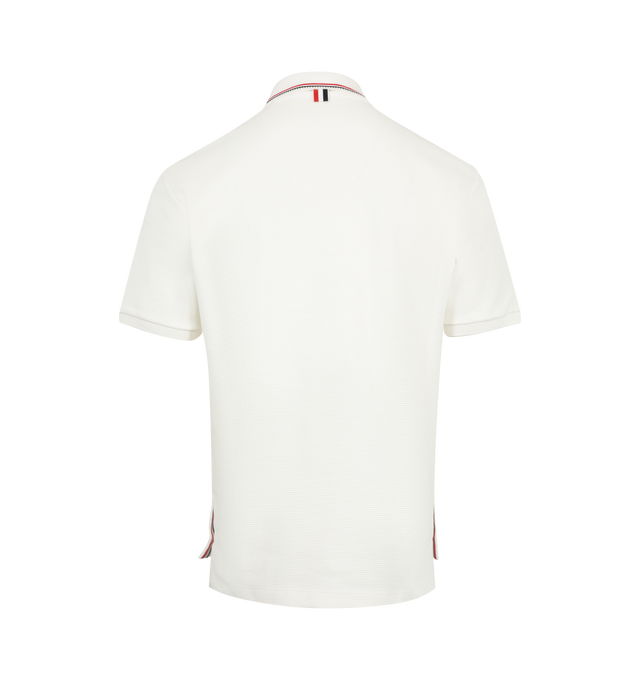 Image 2 of 3 - WHITE - THOM BROWNE Cotton Waffle Rib Cuff Polo featuring partial front button closure, polo collar, short sleeves, name tag applique, buttoned side vents with signature striped grosgrain trim and signature striped grosgrain loop tab. 100% cotton. Made in Italy. 