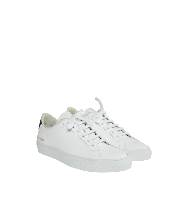 Image 2 of 5 - WHITE - Common Projects  Retro Classic Leather Lace-Up Sneakers in a minimal design crafted from white calf leather with black leather tabs at the heels, detailed with signature gold stamped serial numbers. 