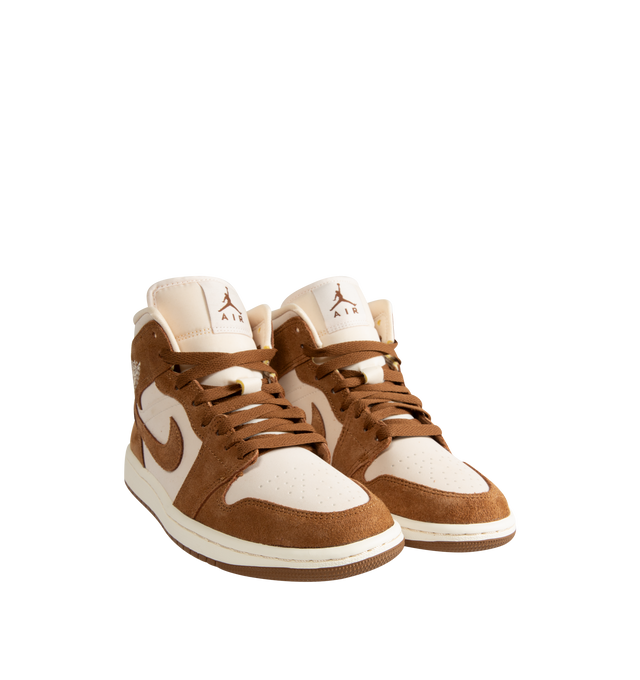Image 2 of 5 - BROWN - Women's Air Jordan 1 Mid Sneakers feature a genuine and synthetic leather upper with a classic mid-top silhouette for durable comfort and timeless style. Inspired by the iconic original, these lifestyle sneakers combine lightweight Air-Sole cushioning, a padded collar, and a durable rubber outsole for everyday support and reliable traction. Main Material: Genuine Leather and Synthetic Leather. Midsole: Foam with Air-Sole Unit. Sole: Rubber. 