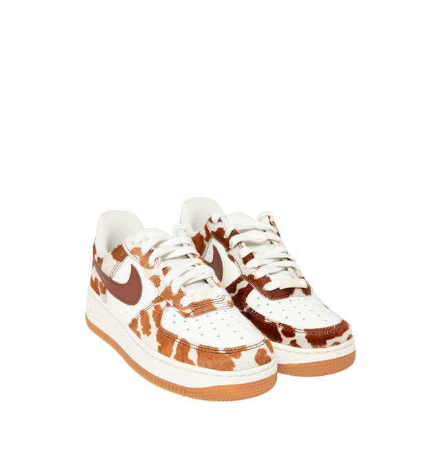 Image 2 of 5 - BROWN - Nike Womens Air Force 1 Sneakers are crafted from pony hair leather with smooth leather overlays. Feature a low-top silhouette, Nike Air cushioning, padded collar, stitched overlays, and a durable rubber cupsole. Main Material: Pony Hair Leather, Leather; Outsole: Rubber. Imported. 