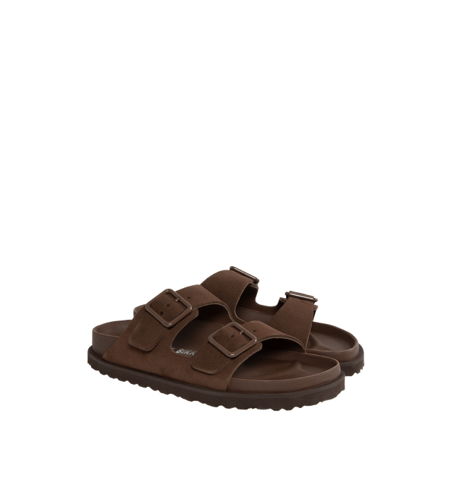 Image 2 of 4 - BROWN - Birkenstock's Arizona sandals in a narrow width. The iconic Arizona sillhouette is  updated in suede featuring adjustable straps with buckle closures, logo details, shaped insole, and EVA outsole. Upper: Luxurious fine flesh out suede, a full grain leather that has been flipped to use the fuzzy side. Footbed: Anatomical shaped BIRKENSTOCK cork-latex footbed, covered with premium, color-matching smooth nappa leather. Sole: EVA outsole with a 3mm EVA welt updates the standard die-cut ou 