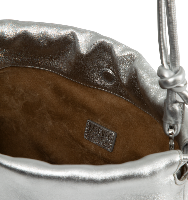 Image 4 of 4 - SILVER - Loewe Medium Flamenco purse in laminated lambskin, defined by a ruched design with key details such as the signature knots at the sides and the donut chain. This medium version is crafted in laminated lambskin. Shoulder, crossbody or hand carry with detachable and adjustable leather strap and detachable donut chain adorned with an Anagram Pebble. Features magnetic closure, suede lining and embossed LOEWE. Height 7.9 X Width 11.8 X Depth 4.1 inches. Made in Spain. 