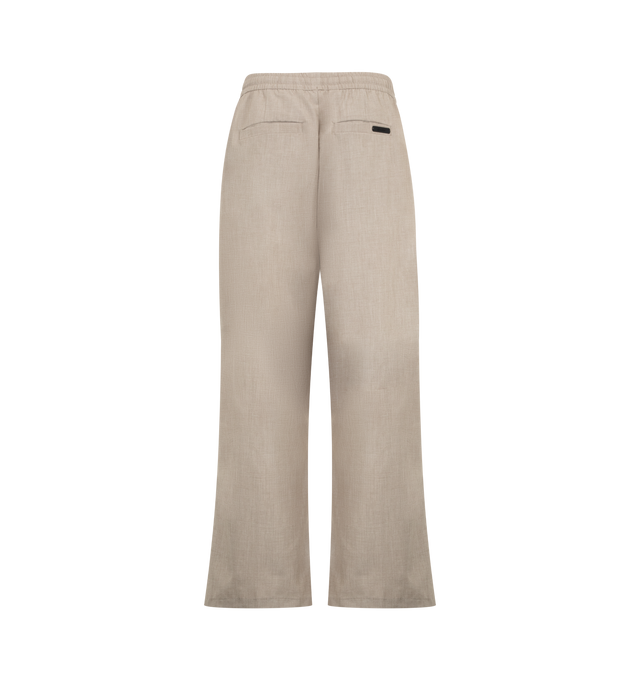 Image 2 of 3 - NEUTRAL - Fear of God Essentials Mens Pleat Front Drawstring Pants are crafted from cotton canvas. Feature a relaxed fit with a relaxed leg and seat, front pleats, elasticized waistband with heavyweight drawstring, side-seam pockets, back welt pockets, and an Essentials signature label. Main Material: 100% Cotton Canvas. 