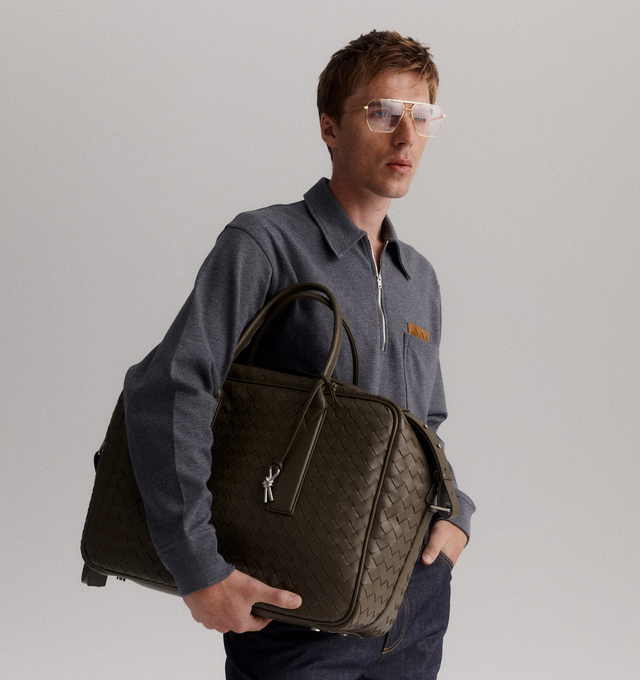 Image 2 of 4 - GREEN - BOTTEGA VENETA Getaway Weekender featuring soft Intrecciato leather with adjustable and detachable strap, signature knot detail, padded laptop compartment, one zipped pocket and zipper closure. Lining: canvas. 13" x 16.9" x 7.5". Handle drop: 6.5". Calfskin. Made in Italy. For personal consultation and detailed information about jewelry, please contact our dedicated stylist team at personalshopping@hirshleifers.com. This item may be restricted for online purchase to international  