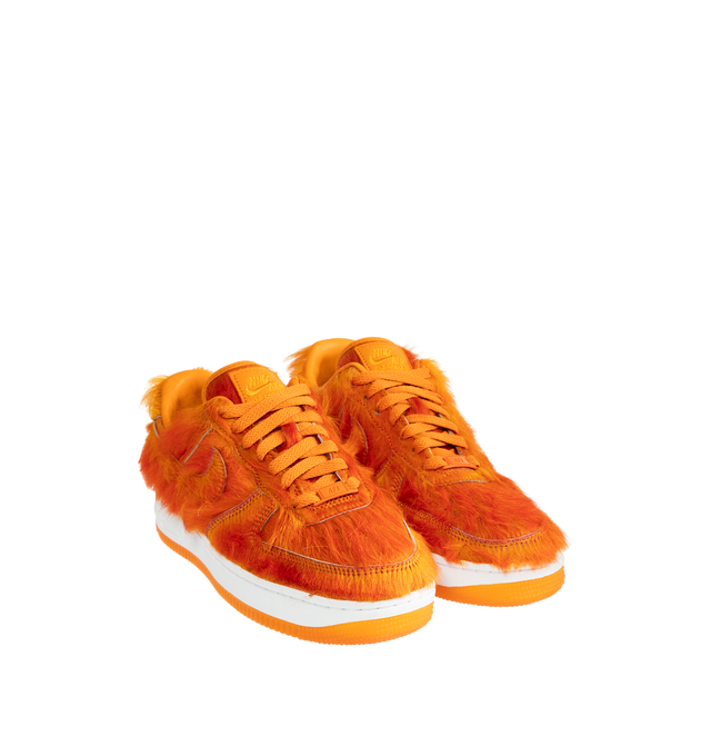 Image 2 of 5 - ORANGE - Nike Air Force 1 "Multi-Color and Sunset" Sneakers update the classic basketball-inspired silhouette with a shaggy, hair-like upper in vivid sunset orange. Tonal Swoosh branding, a lace-up closure, and a padded collar complete the low-top design, while a white Air-cushioned midsole and orange rubber outsole provide comfort and traction. Sole: Rubber. 