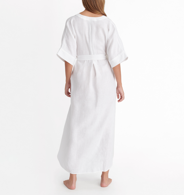 Image 3 of 4 - WHITE - ERES Bibi Kaftan featuring short sleeves, V-neckline, pleated back, removable belt without loop, rounded slits on each side at the bottom and length above ankles. 100% Linen. Made in Bulgaria. 