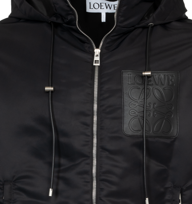 BLACK - LOEWE Hooded Padded Jacket featuring regular fit, regular length, all over padded effect, hooded collar with leather drawstring, elasticated cuffs, zip front fastening, zipped welt pockets, inside welt pocket, LOEWE jacquard lining and LOEWE Anagram embossed leather patch pocket placed on the chest. 100% polyamide.