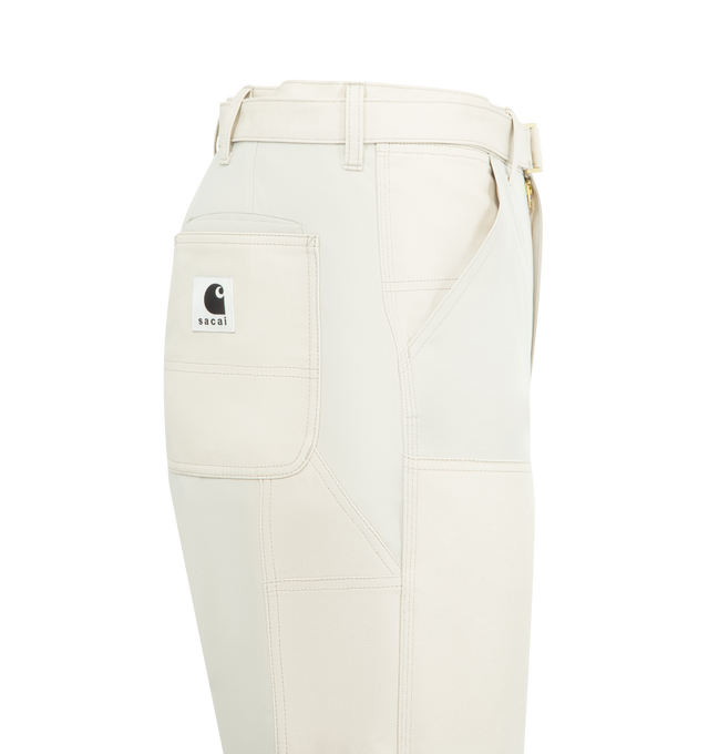 Image 3 of 3 - WHITE - SACAI X CARHARTT Duck Pants featuring a cargo-inspired silhouette with double-knee various patch pockets, a woven belt, side and back patch pockets and zip fly, button closure. 100% cotton. Made in Japan. 