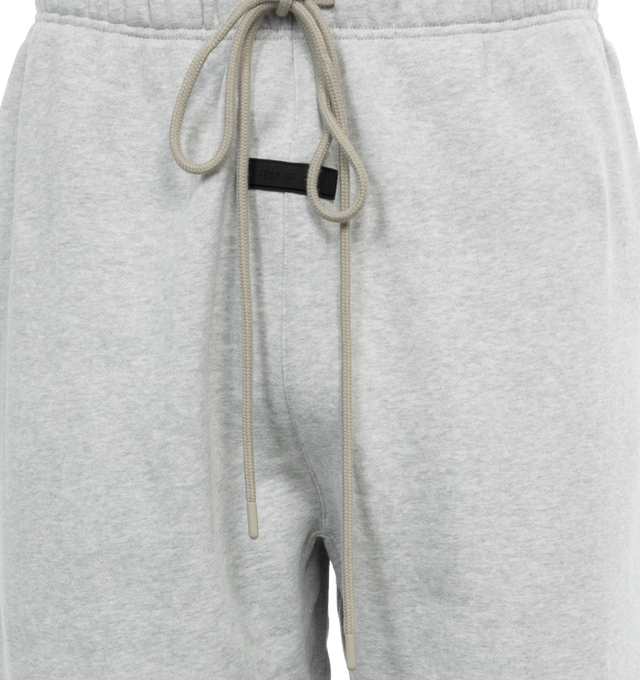 Image 4 of 4 - GREY - FEAR OF GOD ESSENTIALS Drawstring Sweatpants featuring drawstring at elasticized waistband, two-pocket styling, rubberized logo patch at front and elasticized cuffs. 80% cotton, 20% polyester. Made in Viet Nam. 